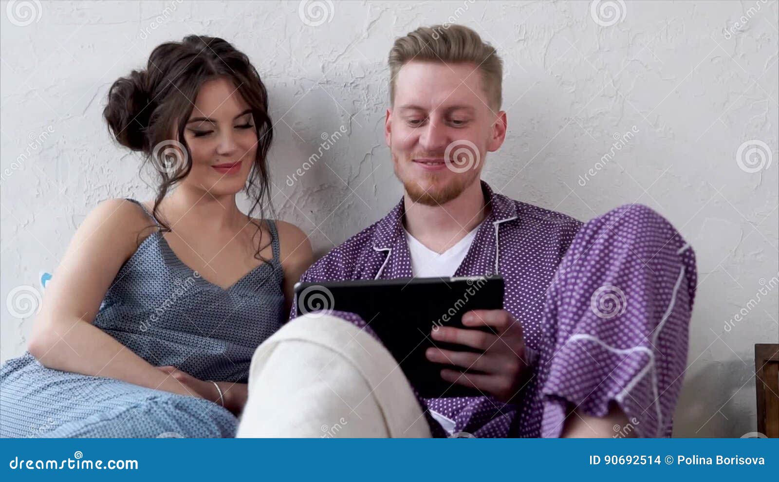 Young Couple Watching Videos on Tablet