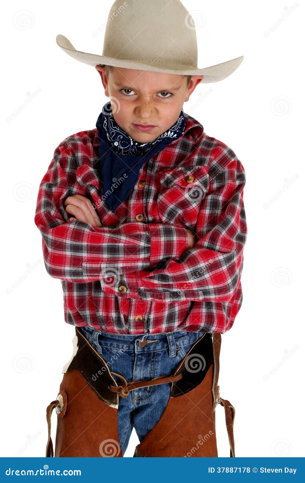 young cowboy glaring at camera wearing hat and cha