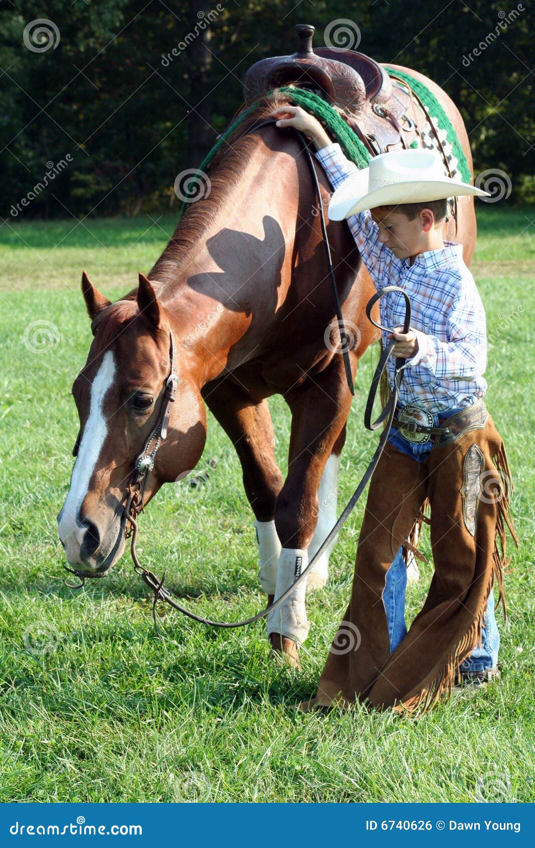 young cowboy and horse