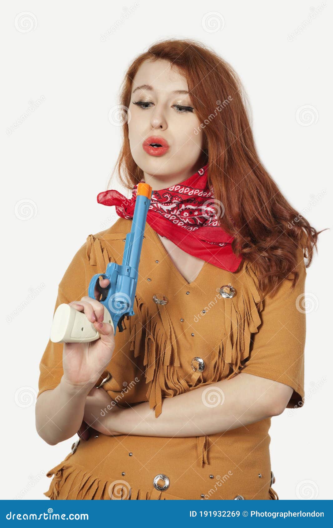 Young Cowgirl With Toy Pistol Against Gray Ba