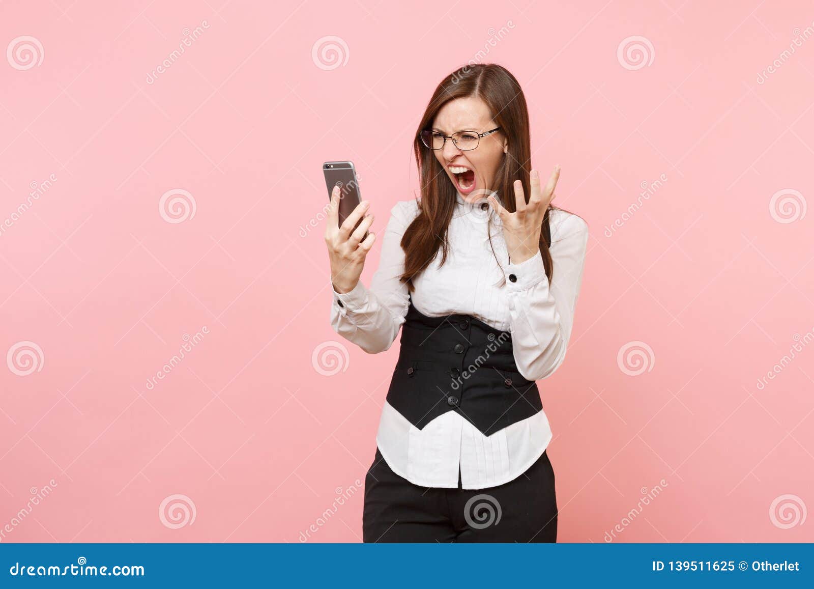Young Crazy Angry Business Woman in Black Suit, Glasses Screaming Holding Mobile Phone Spreading Hands on Pink Stock Image - Image of manager, businesswoman: 139511625