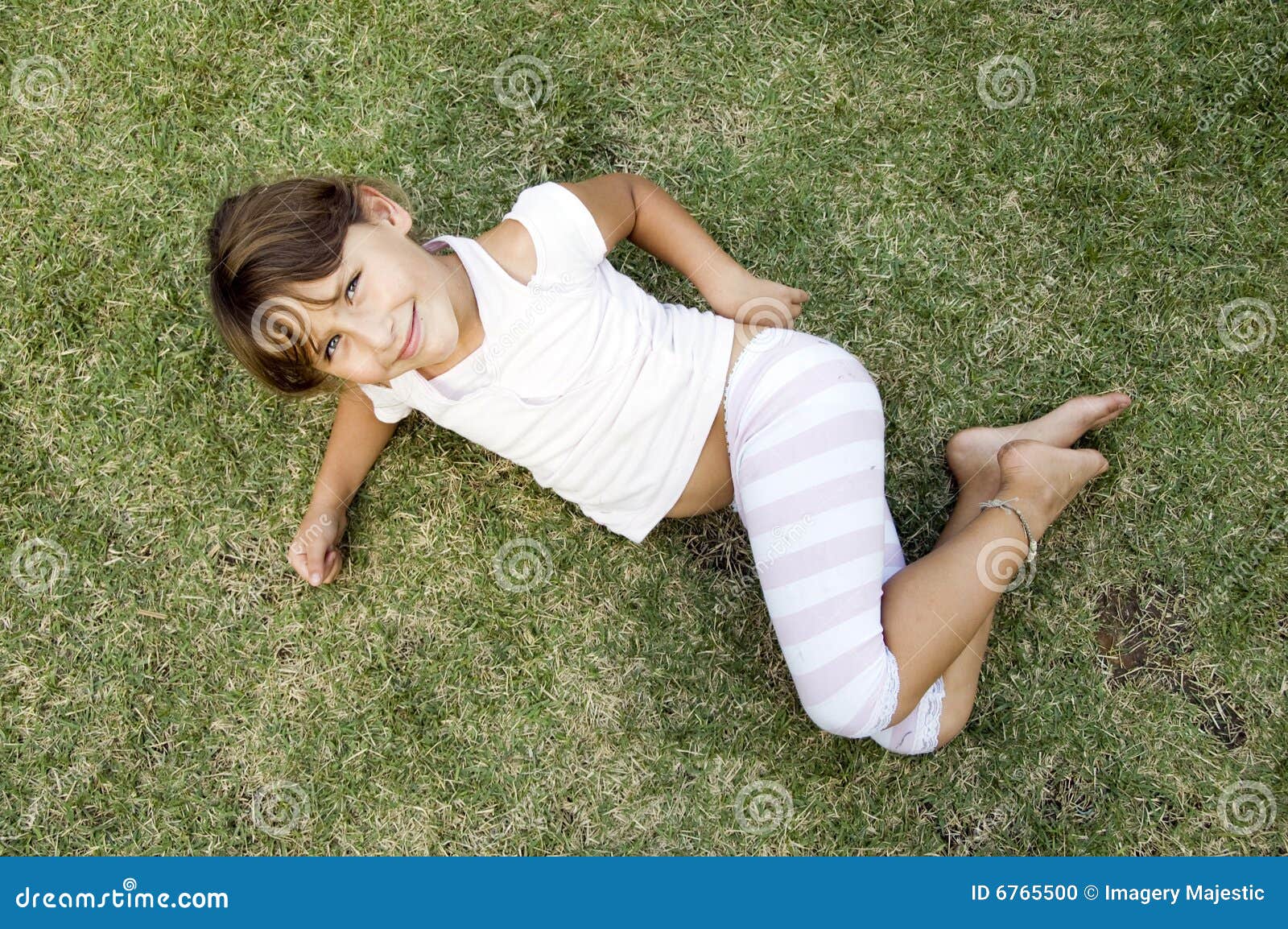 Young Cute Girl Lying on the Grass Stock Photo - Image of play, cute