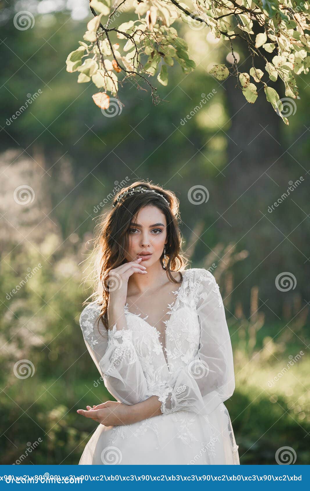 A Young Cute Girl in a White Dress Poses Beautifully. Positive