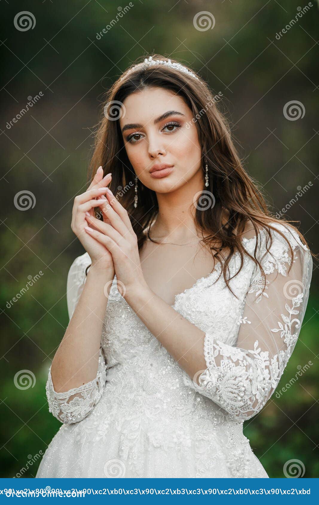 A Young Cute Girl in a White Dress Poses Beautifully. Positive