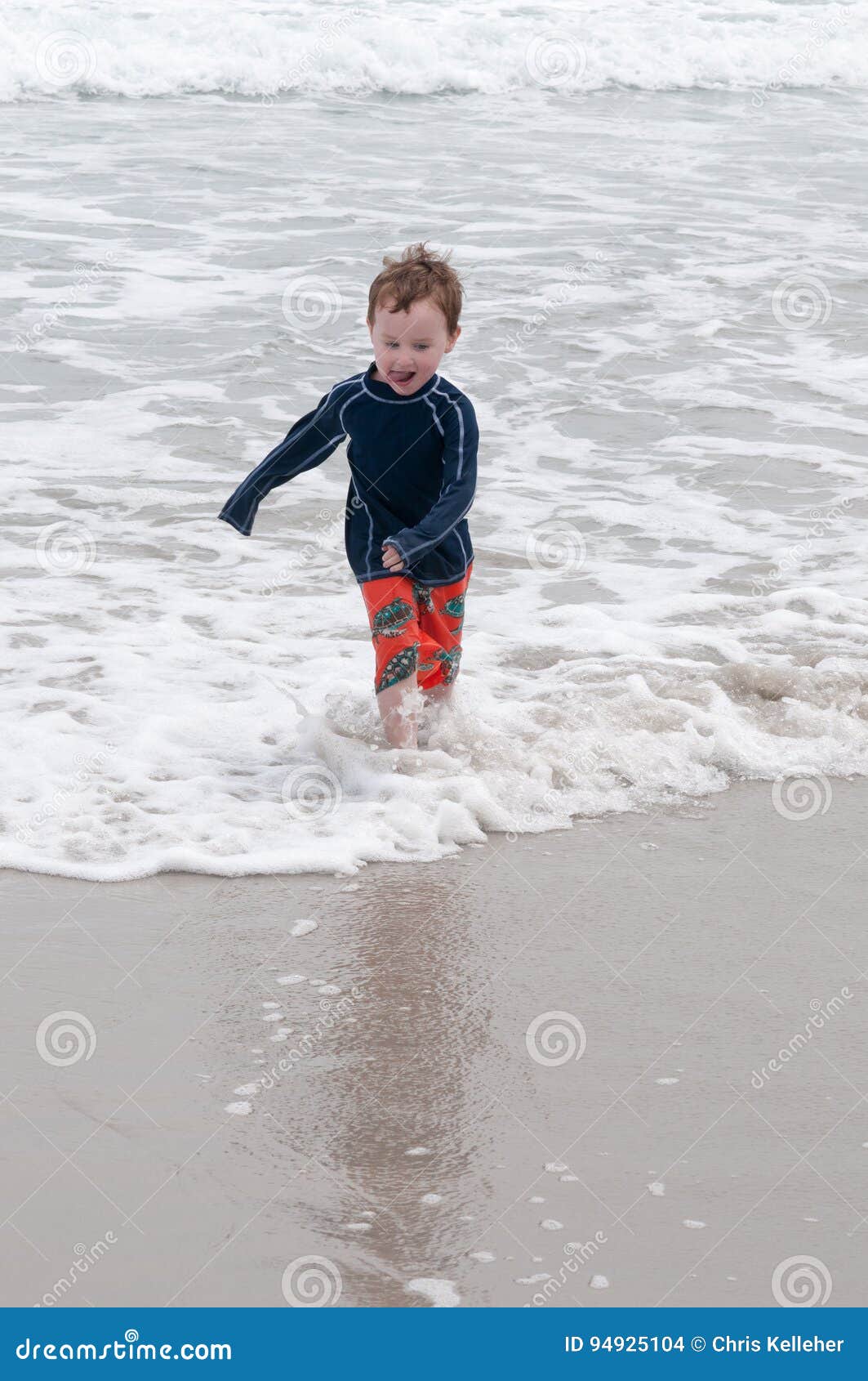 Young Cute Little Boy Playing at the Seaside Running into the Surf on a ...