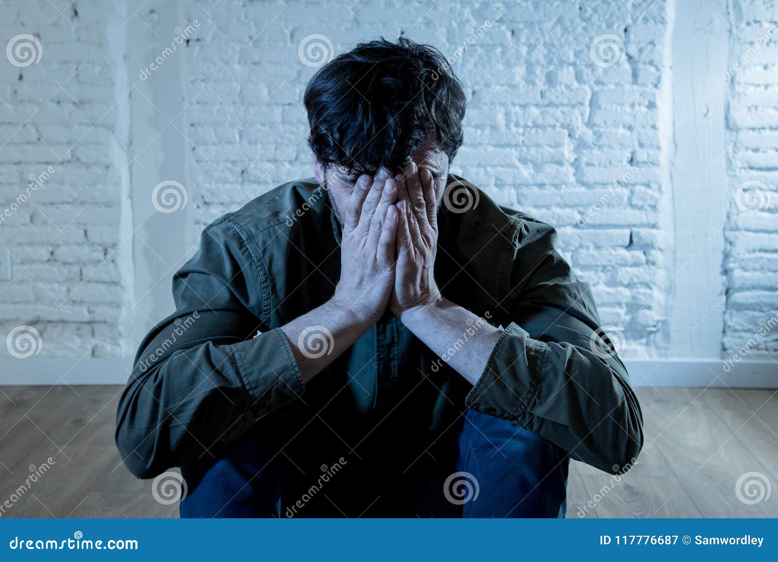 Sad Depressed Man Leaning Against a Wall in Mental Health Concept Stock ...