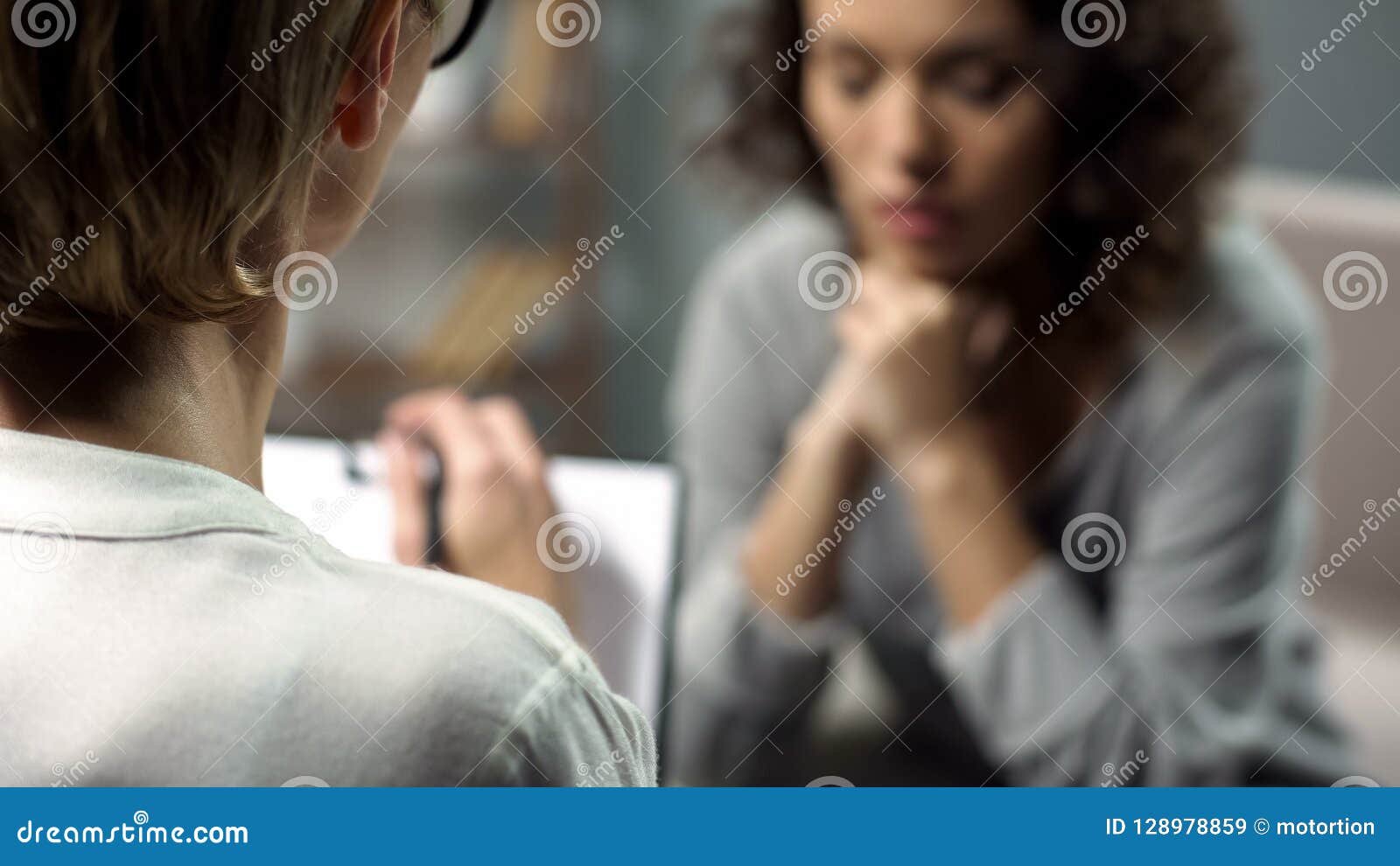 young depressed woman talking to lady psychologist during session, mental health