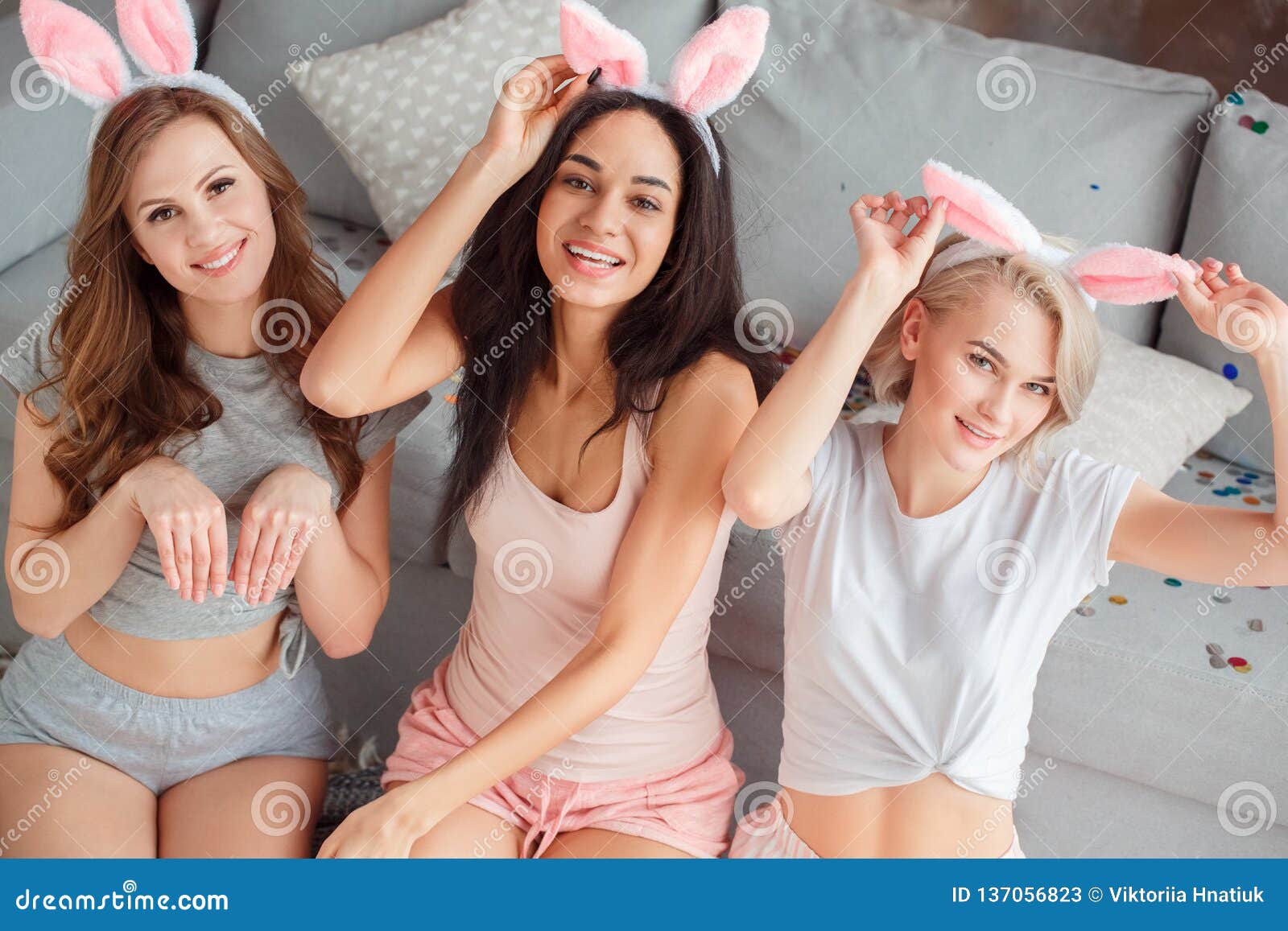 Three glad diverse millennial women in undergarments sit on floor, enjoy  body positivity Stock Photo by Prostock-studio