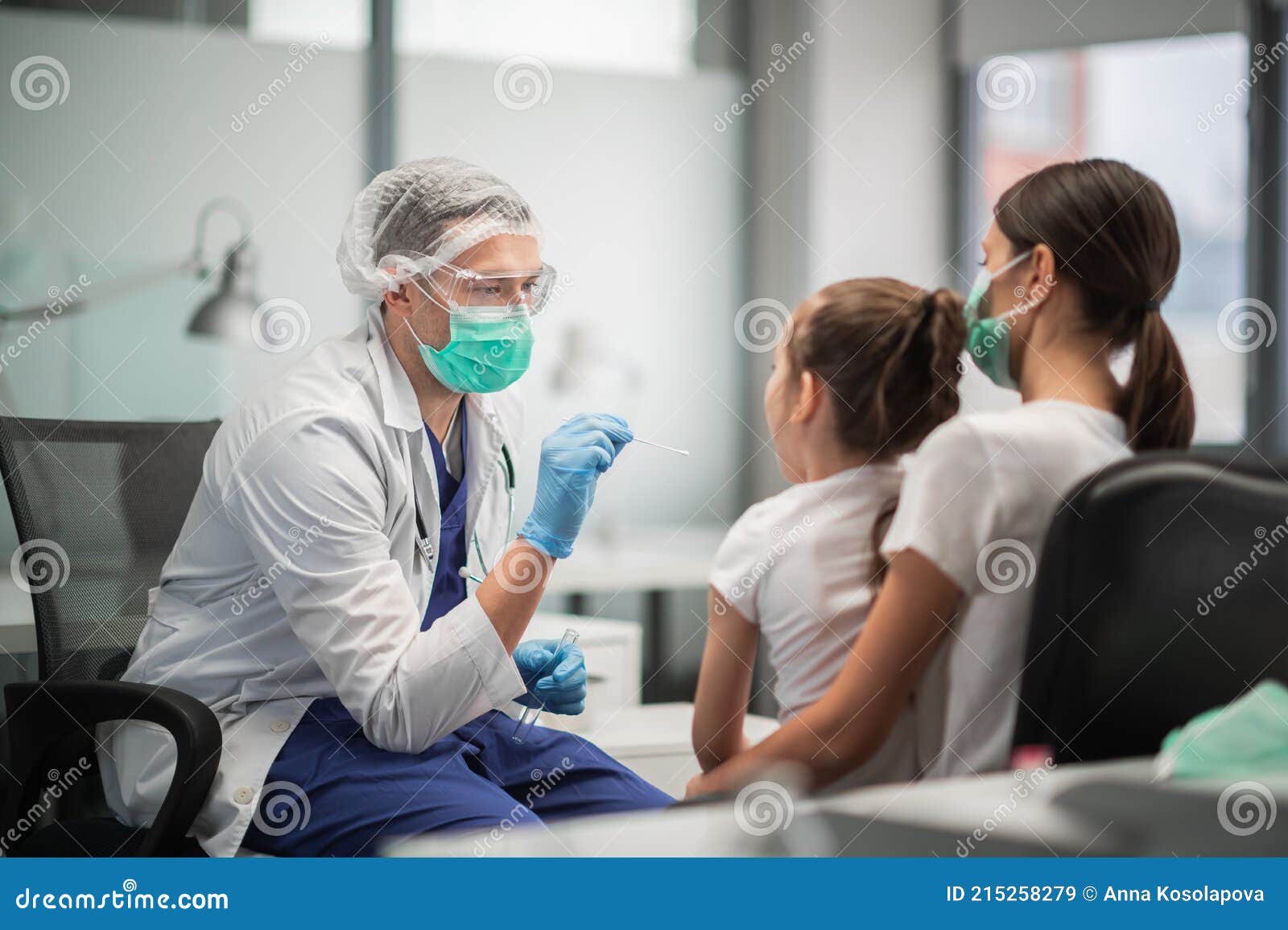 a young doctor conducts an analysis for coronavirus in the laboratory of a girl, takes a smear from the nasopharynx