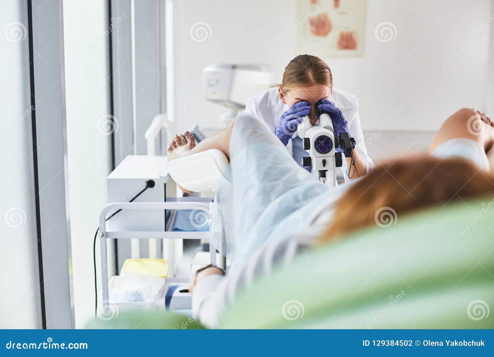 young doctor doing gynecological examination of female patient