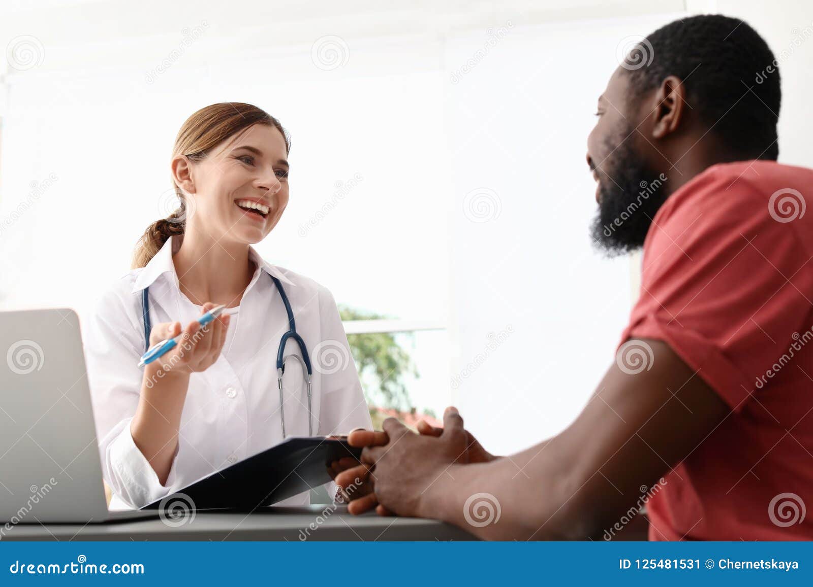 young doctor speaking to african-american patient