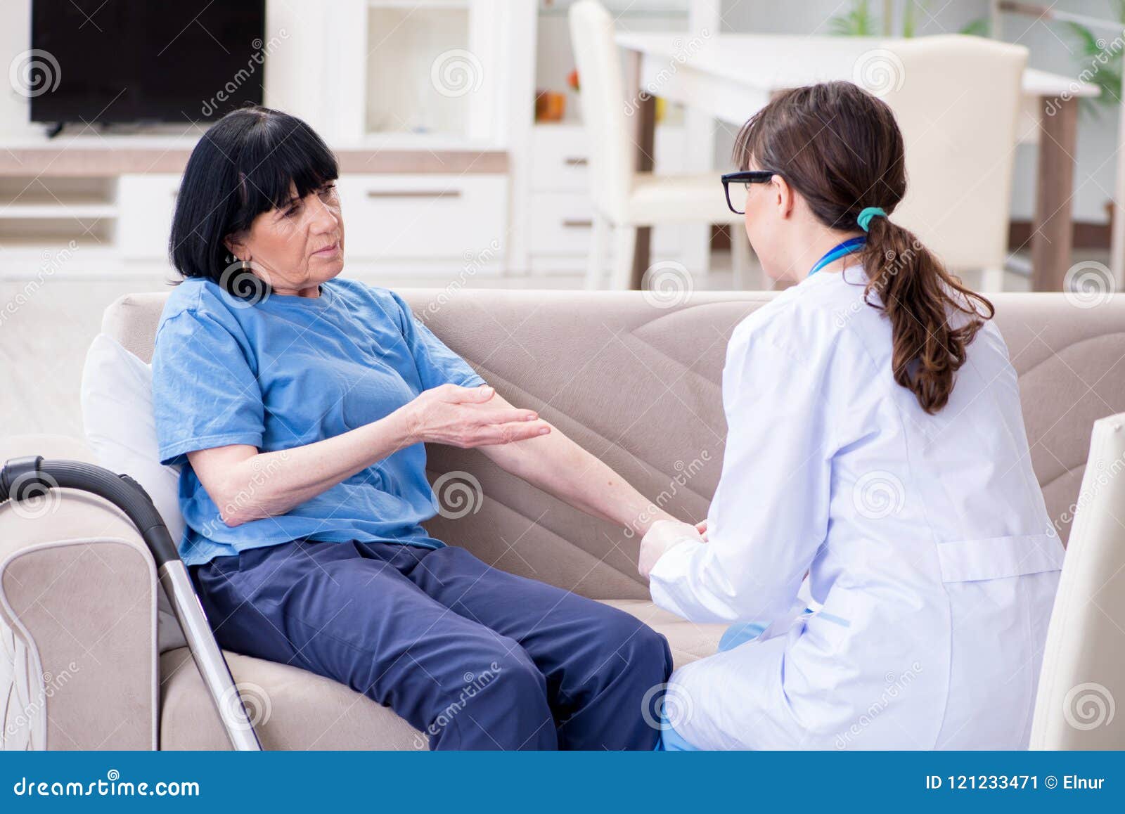 The Young Doctor Visiting Old Mature Woman For Check Up Stock