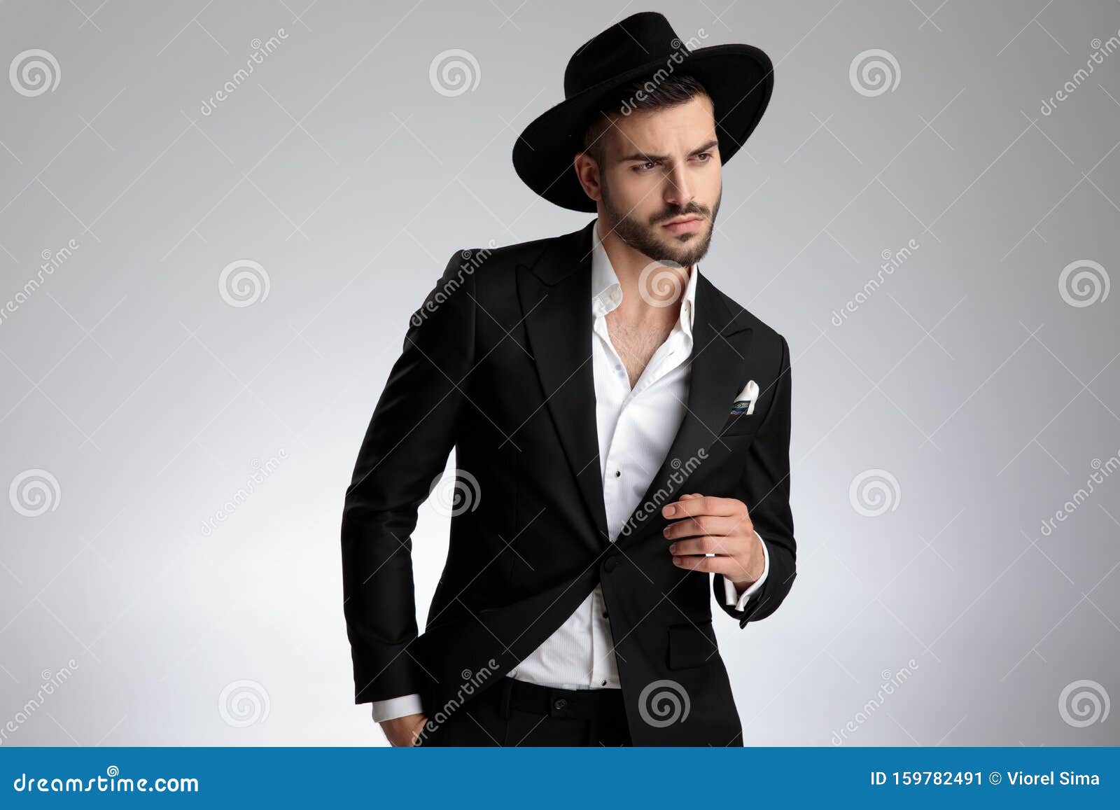 Young Elegant Fashion Model Wearing Tuxedo and Black Hat Stock Image ...