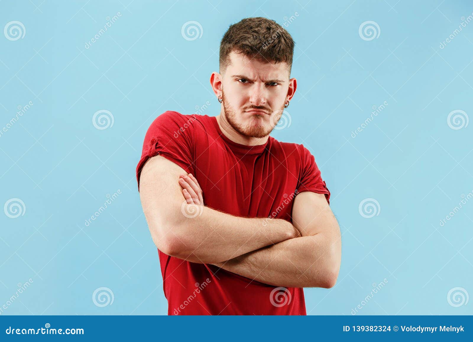 The Young Emotional Sad Angry Man on Blue Studio Background Stock ...
