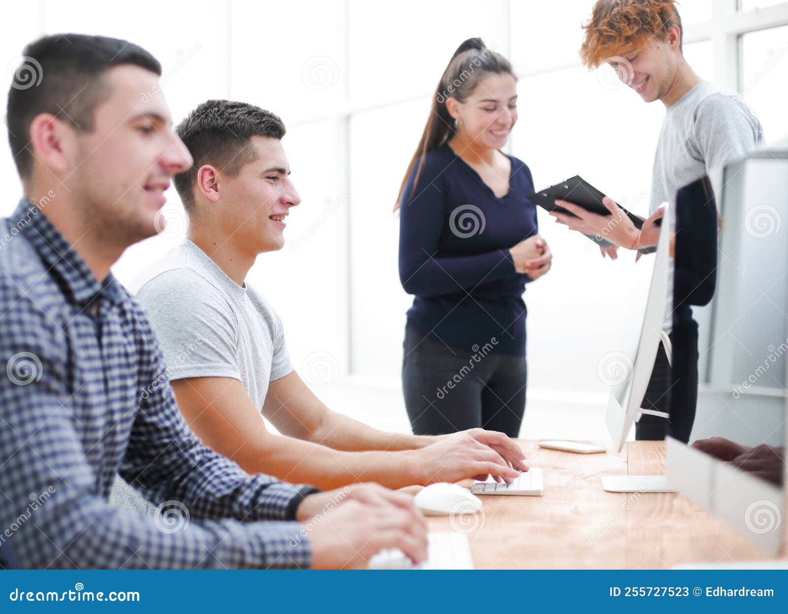 Young Employees Sitting at the Office Desk. Stock Image Image of male
