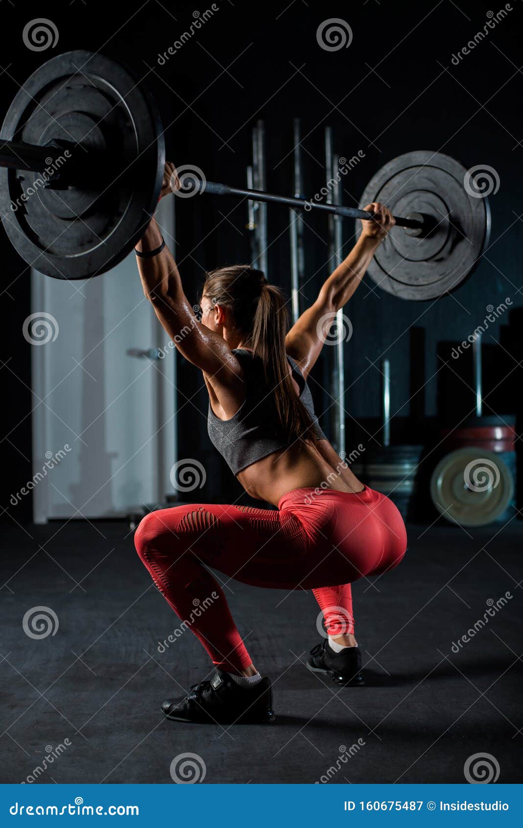 Young, European, muscular girl in red leggings, doing exercise