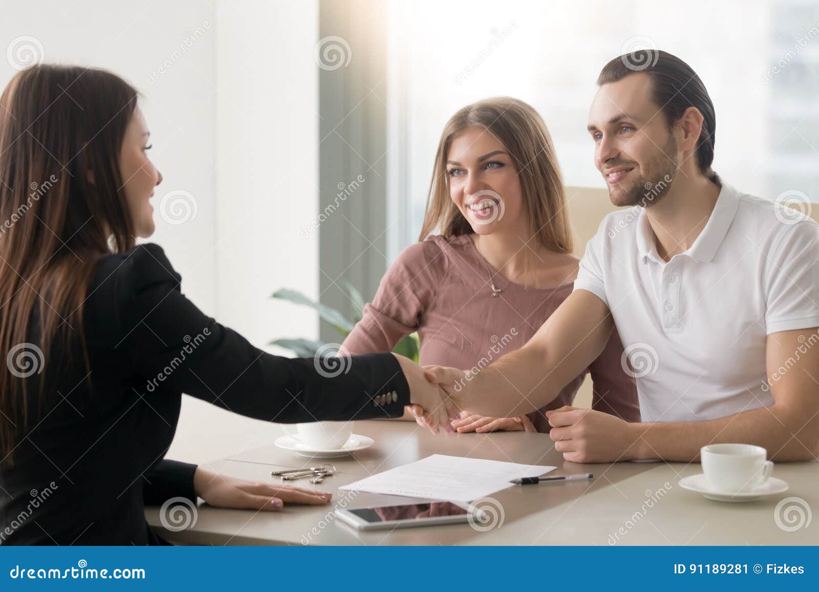 young family couple meeting with broker, handshake izing a
