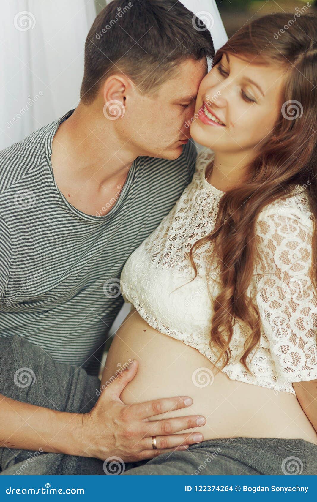 Young Family Couple Portrait, Husband and Pregnant Wife Kissing ...