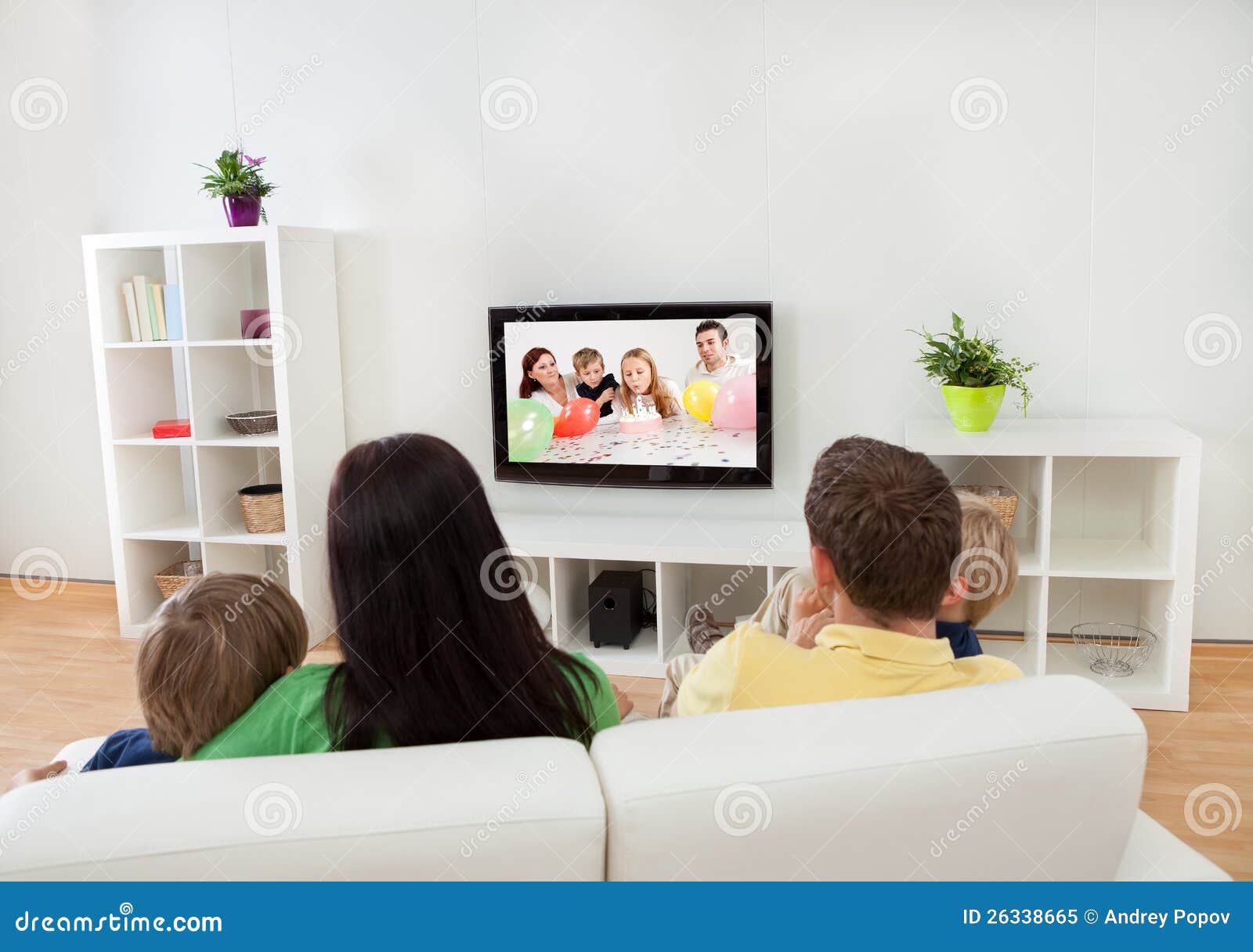 young family watching tv