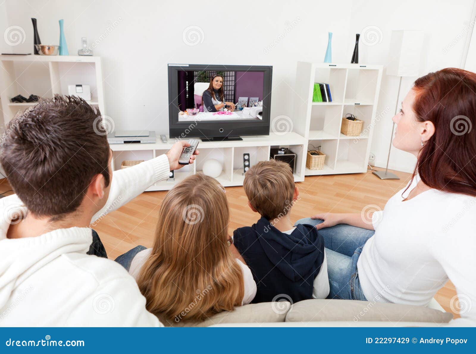 young family watching tv at home