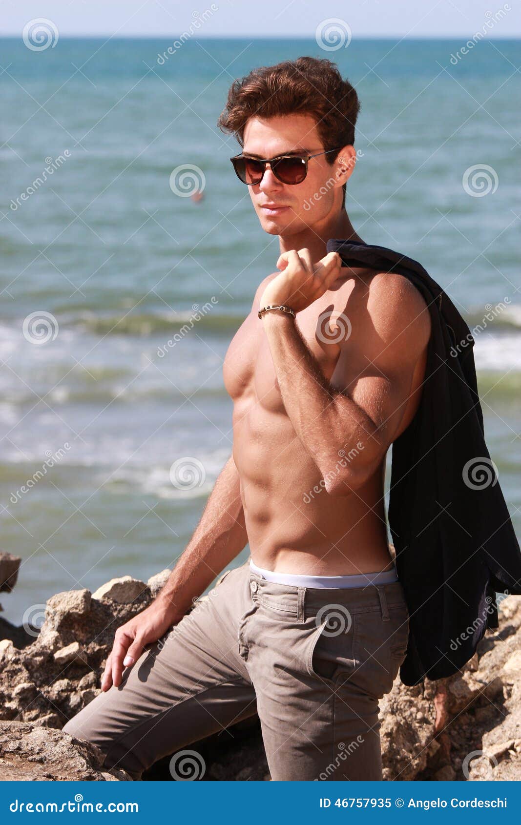 Young Fashion Boy Posing at the Sea Near the Rock. Shirtless and Sunglasses  Stock Image - Image of atmosphere, environs: 46757935