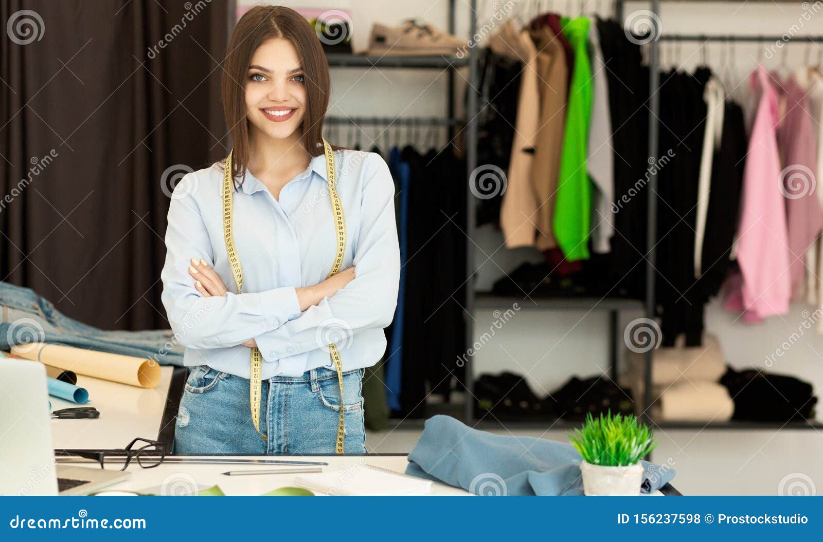 Young Fashion Designer Smiling at Camera in Clothing Showroom Stock ...