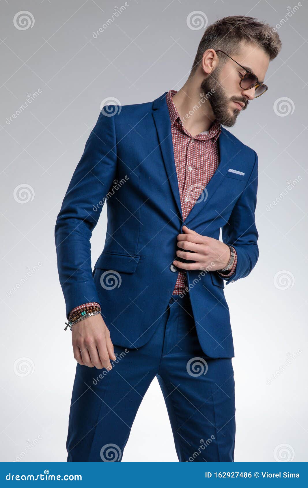 Young Fashion Man in Blue Suit Standing in a Fashion Pose Stock Photo ...