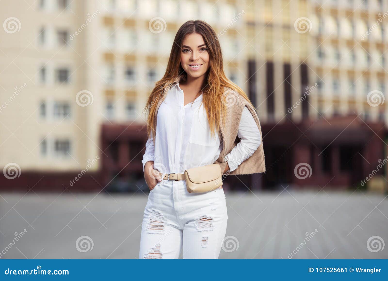 Young Fashion Woman in White Blouse and Ripped Jeans Walking in City ...