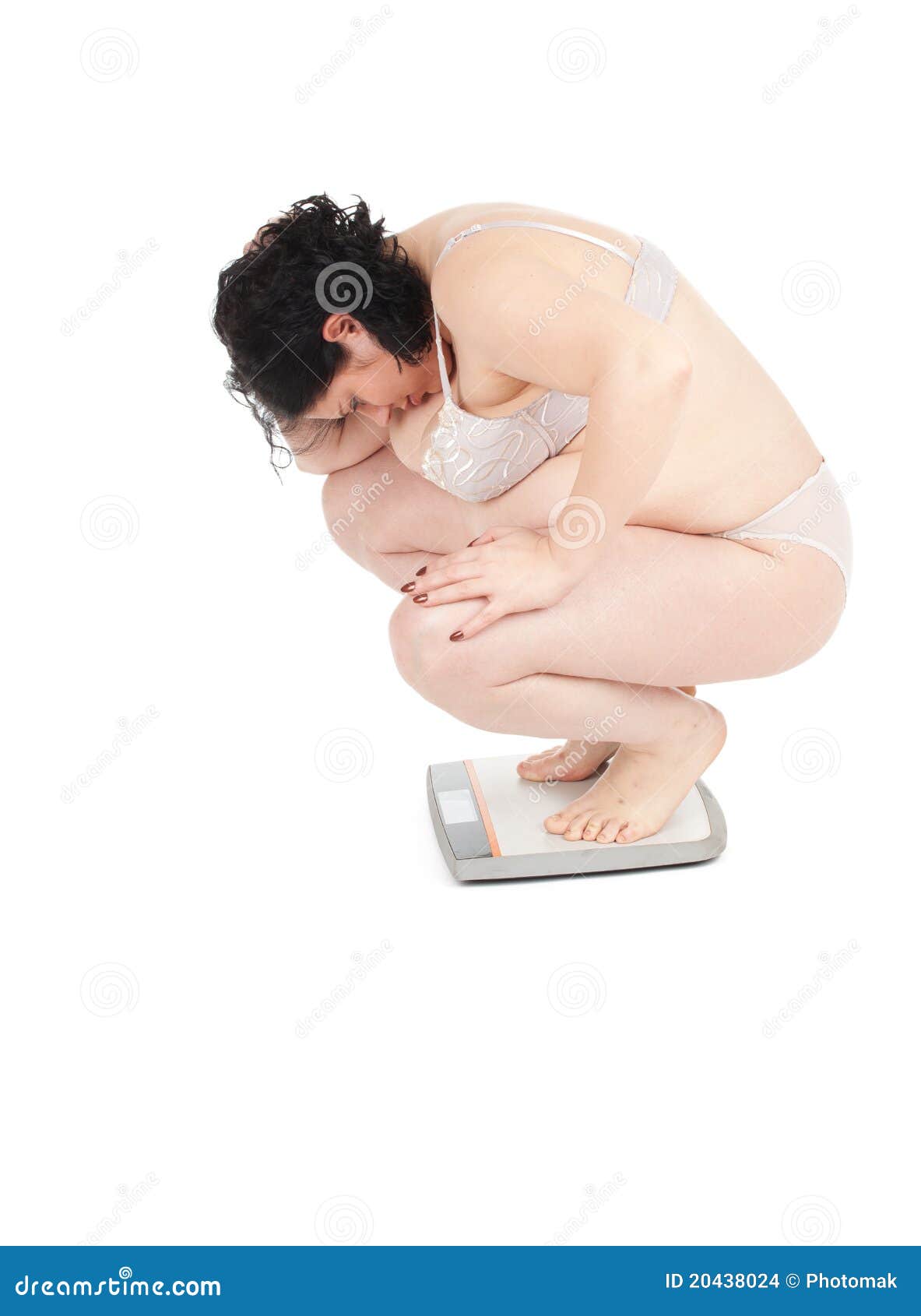 Young fat woman on scale stock photo