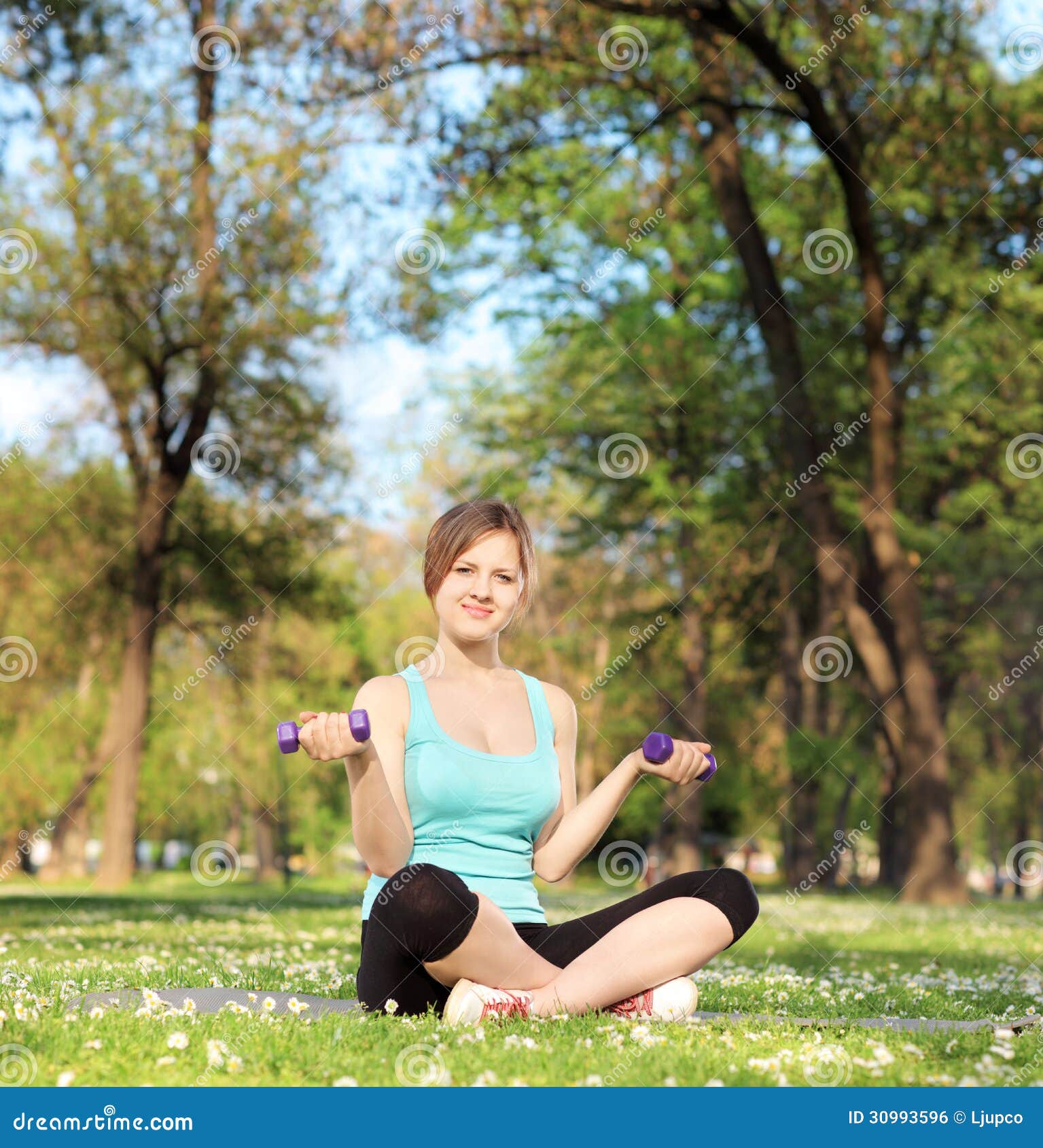 Young Female Athlete Exercising with Dumbbells in Park Stock Photo