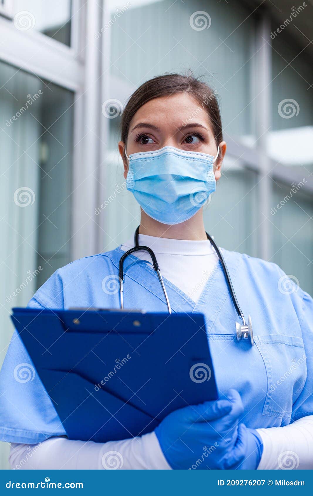 young female caucasian uk nhs gp doctor looking in distance