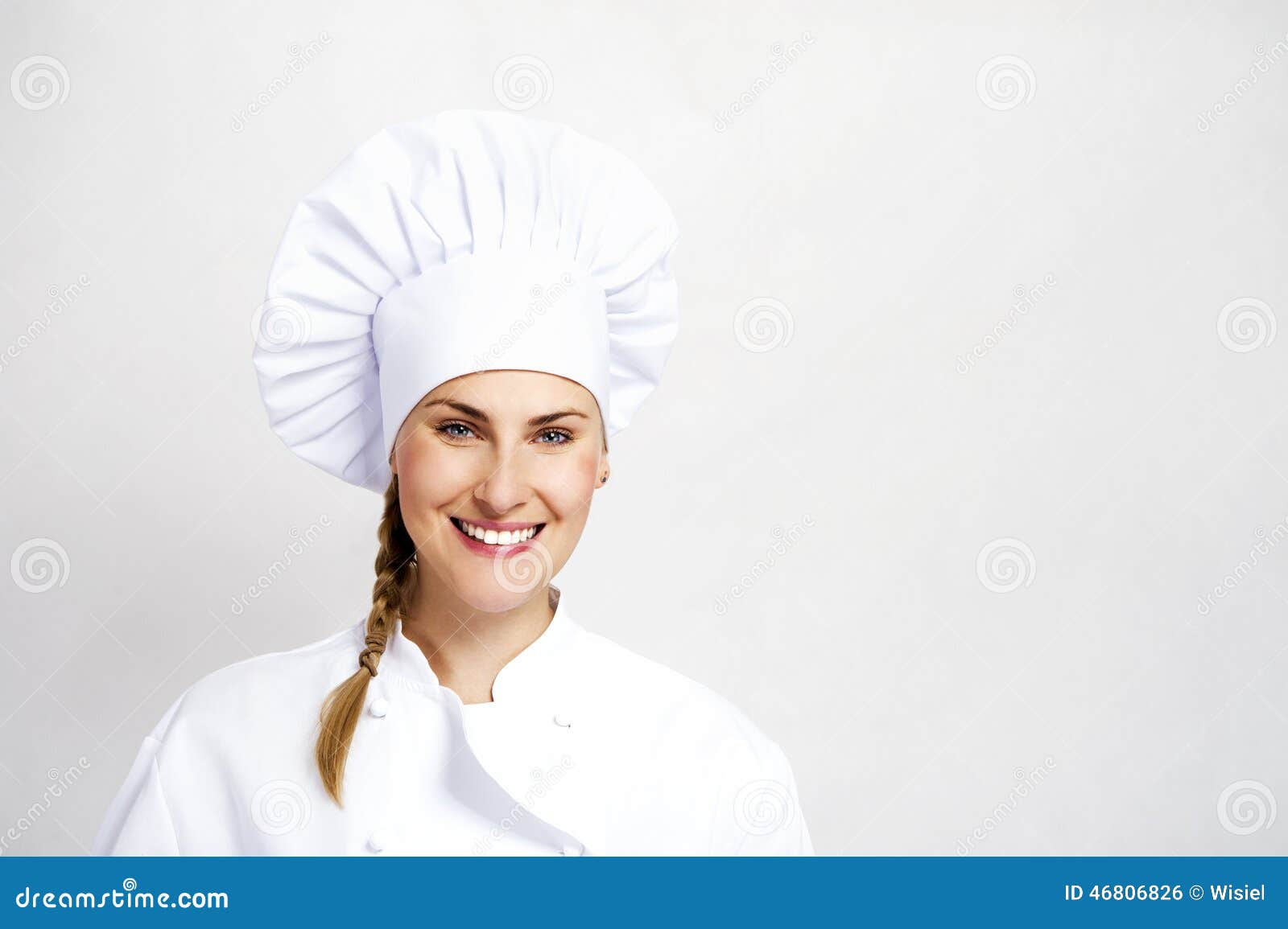 A Young, Female Chef in a Traditional Hat and Coat. Stock Photo Image
