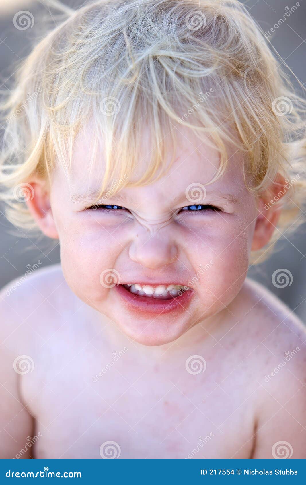 young female child or toddler with cheeky grin on her face