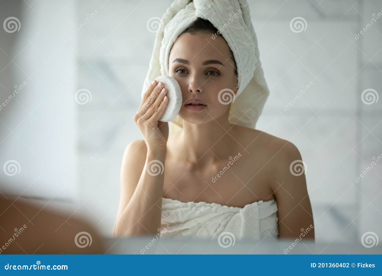 young female with delicate sensitive skin trying new facial sponge