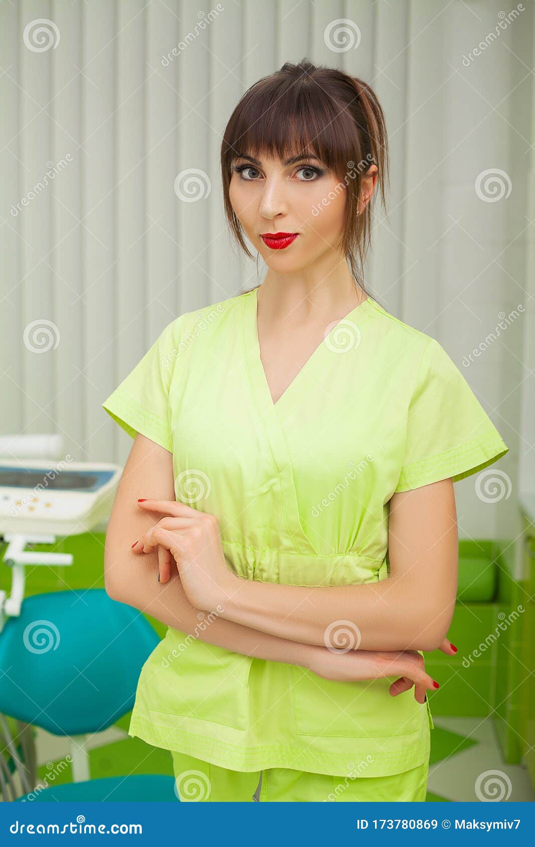 Young Female Dentist in Green Coat at Workplace. Stock Image Image of