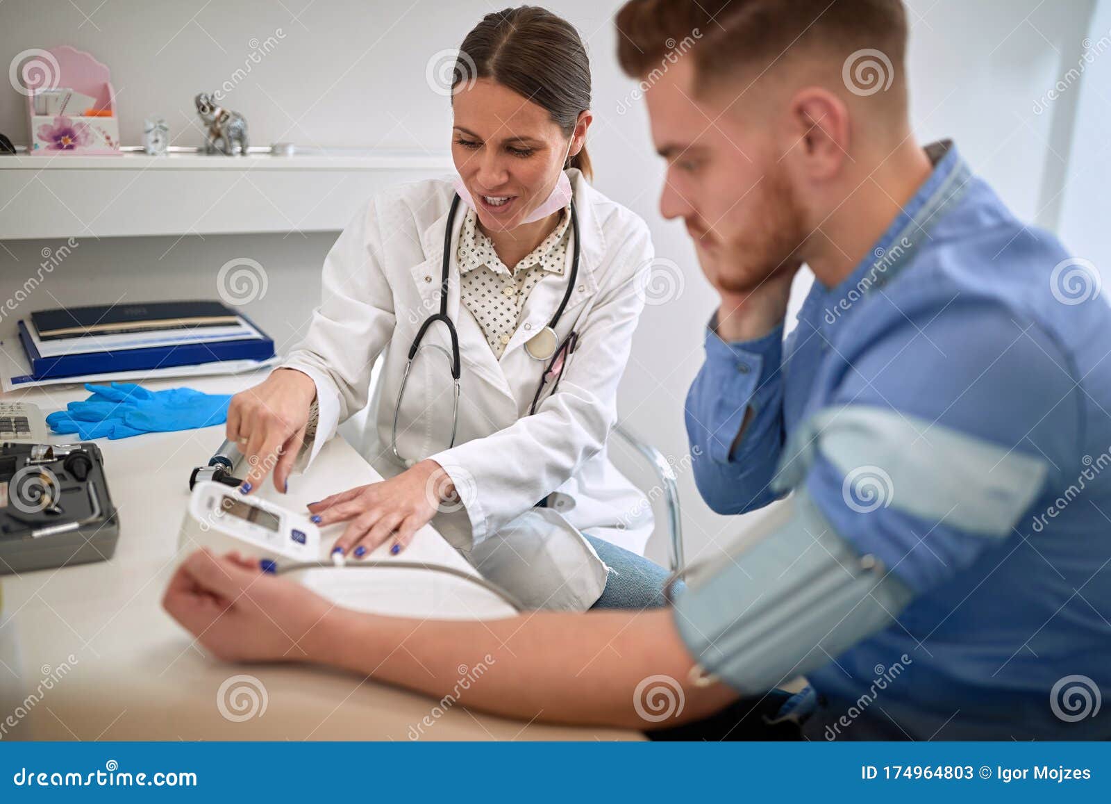 Female Doctor Measuring Blood Pressure Stock Image - Image 