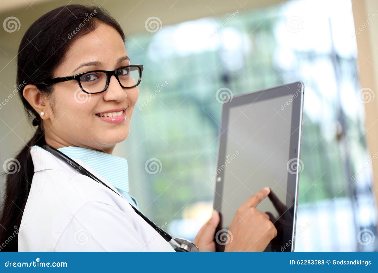 Young Female Doctor Using Tablet Computer Stock Photo - Image of coat ...