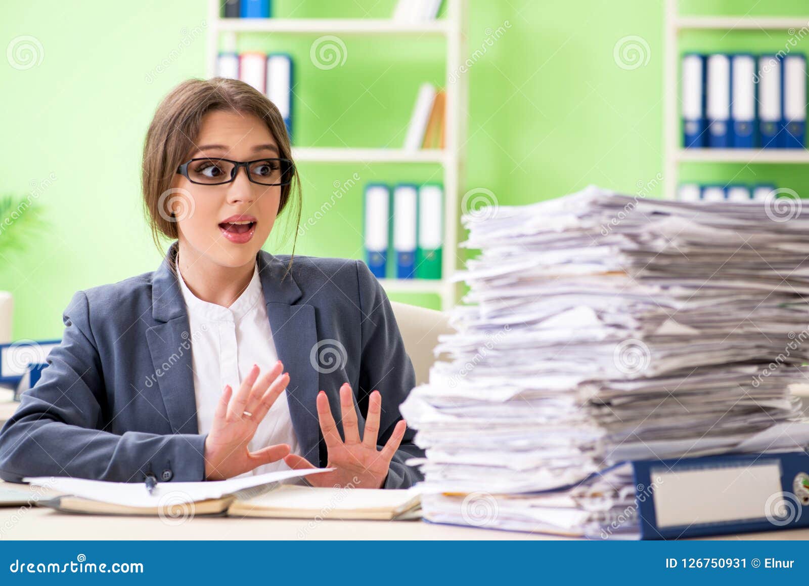 the young female employee very busy with ongoing paperwork