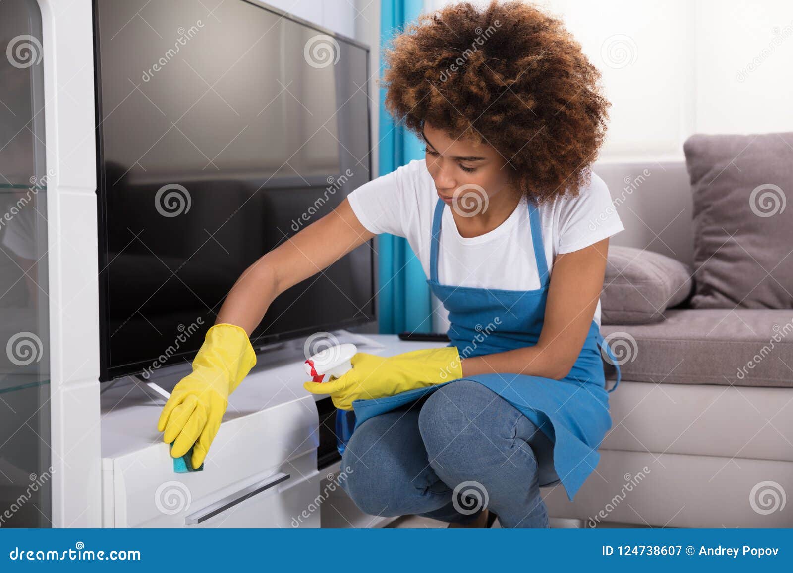 janitor cleaning furniture with sponge