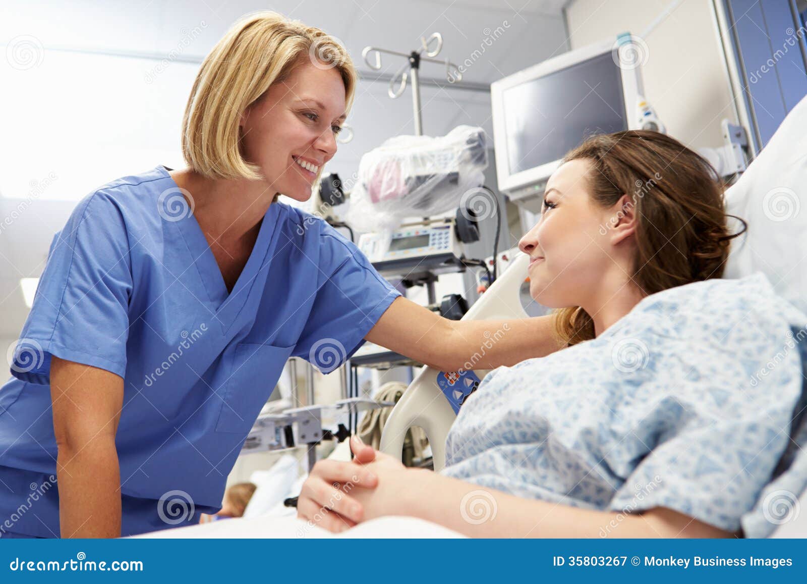 young female patient talking to nurse in emergency room