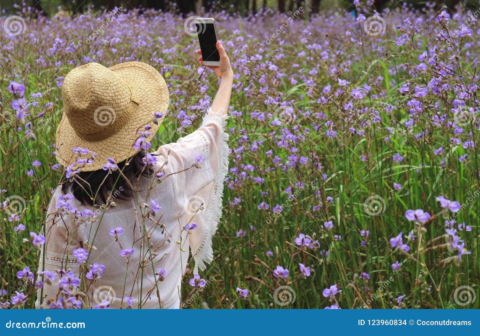 Young Female Taking Selfie Picture in the Flower Field with Her Mobile ...