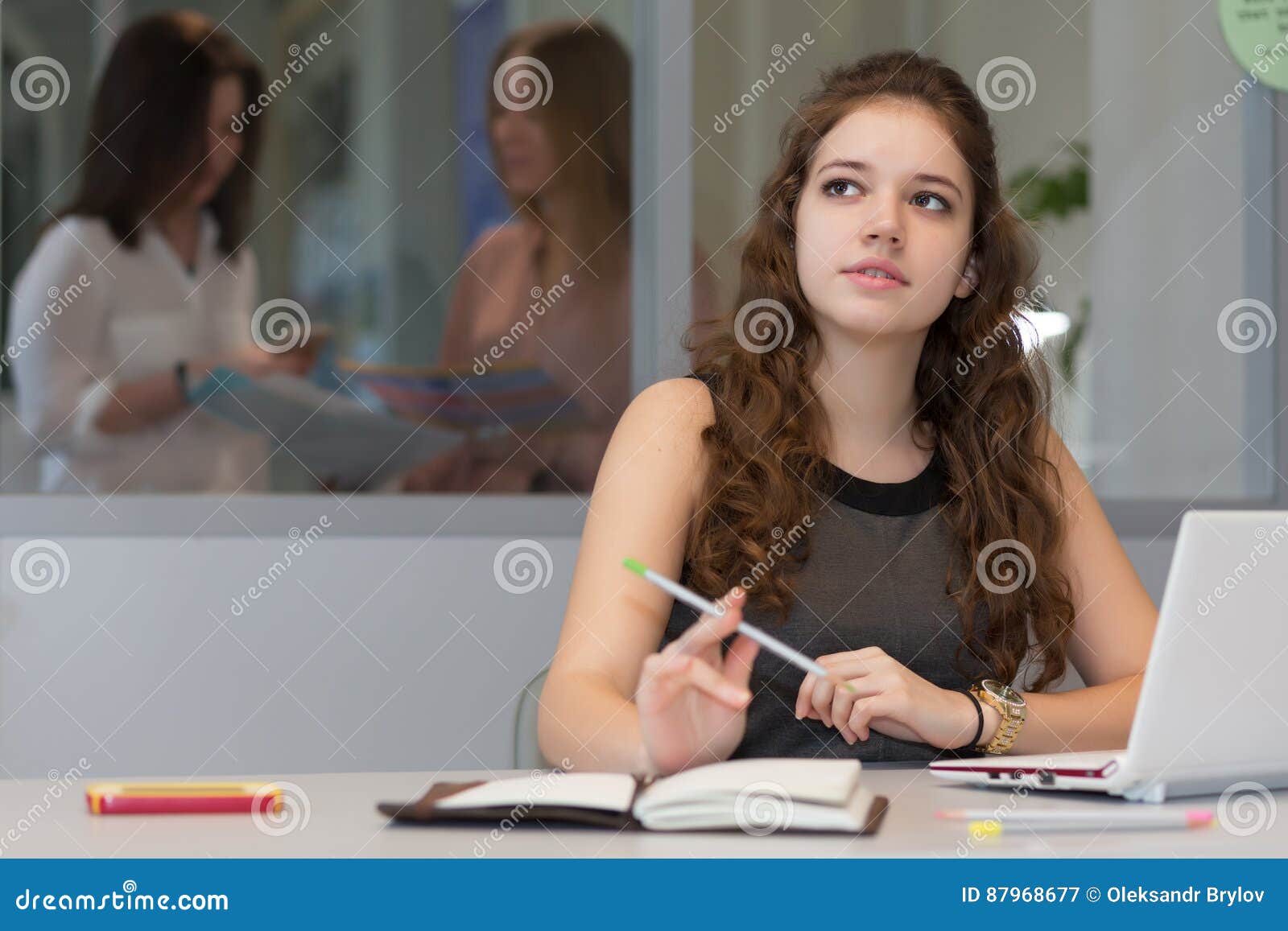 Young Female Trainee Working Laptop Office Interior Business Computer Grey Desk Pensively Looking Aside Thinking 87968677 