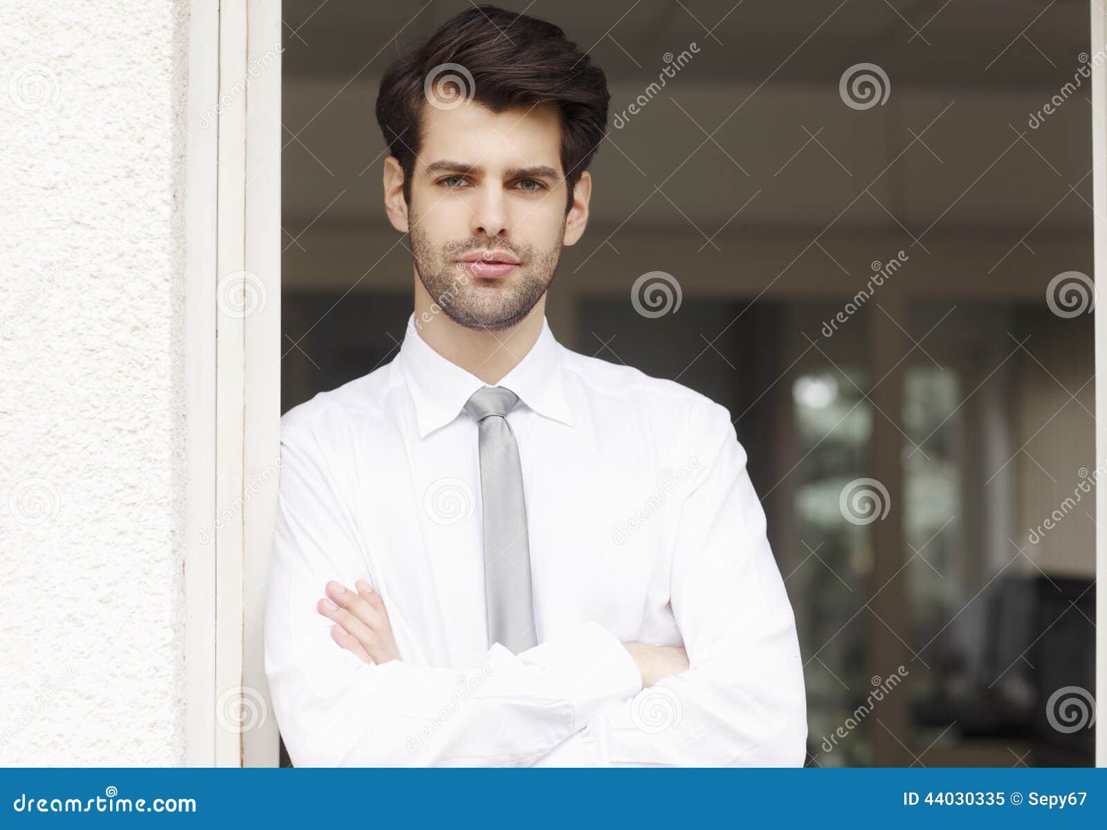 Young financier. Portrait of executive young financial businessman standing at office. Business people.