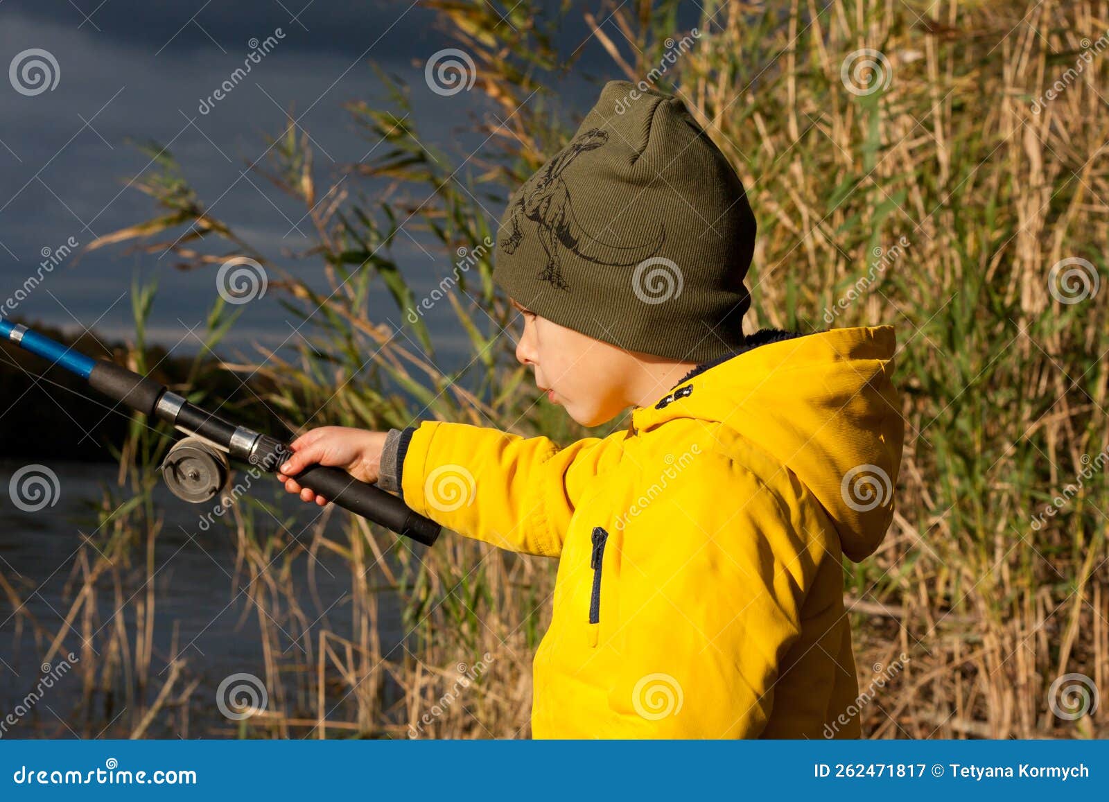 Young Fisherman. Preschooler Boy, Dressed in Yellow Jacket, is