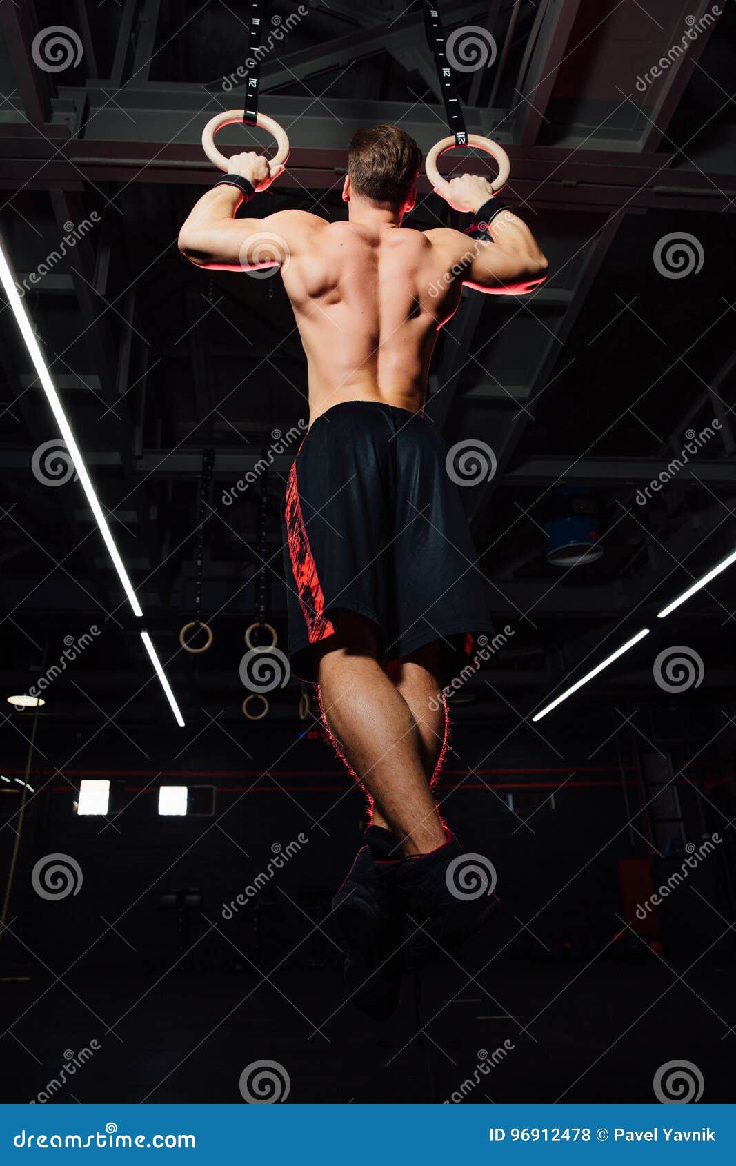 Young Fit Man Pulling Up on Gymnastic Rings. Stock Photo Image of club, beautiful 96912478