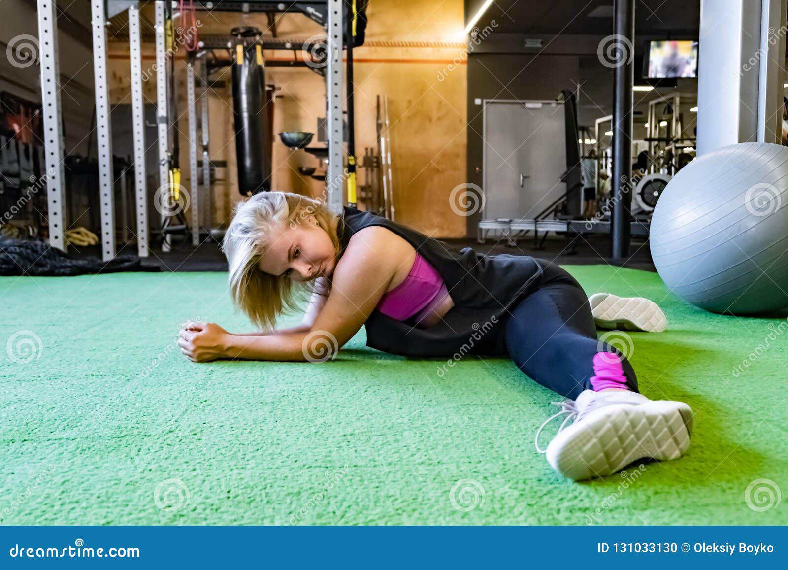 Working out Young athletic sportswoman exercising on gymnastic