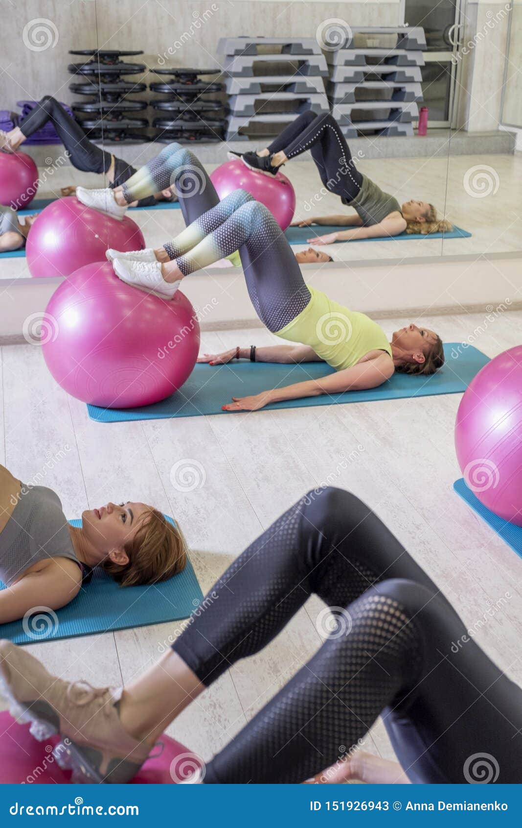 Young Fit Women on a Yoga Pilates Group Class in Gym. they Stretch, Stay in  Asana Poses in Sport Outfit. Daylight Stock Image - Image of poses, adult:  151926943