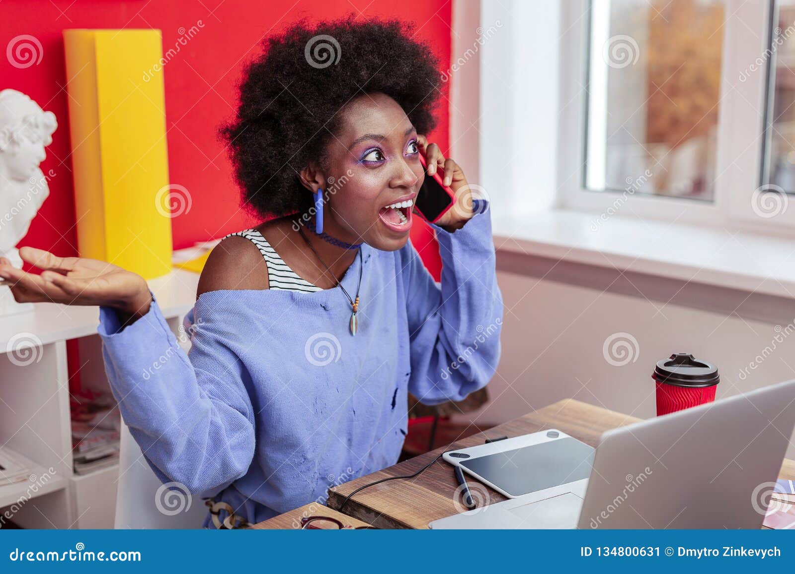 young freelancer feeling extremely emotional receiving cal from old friend