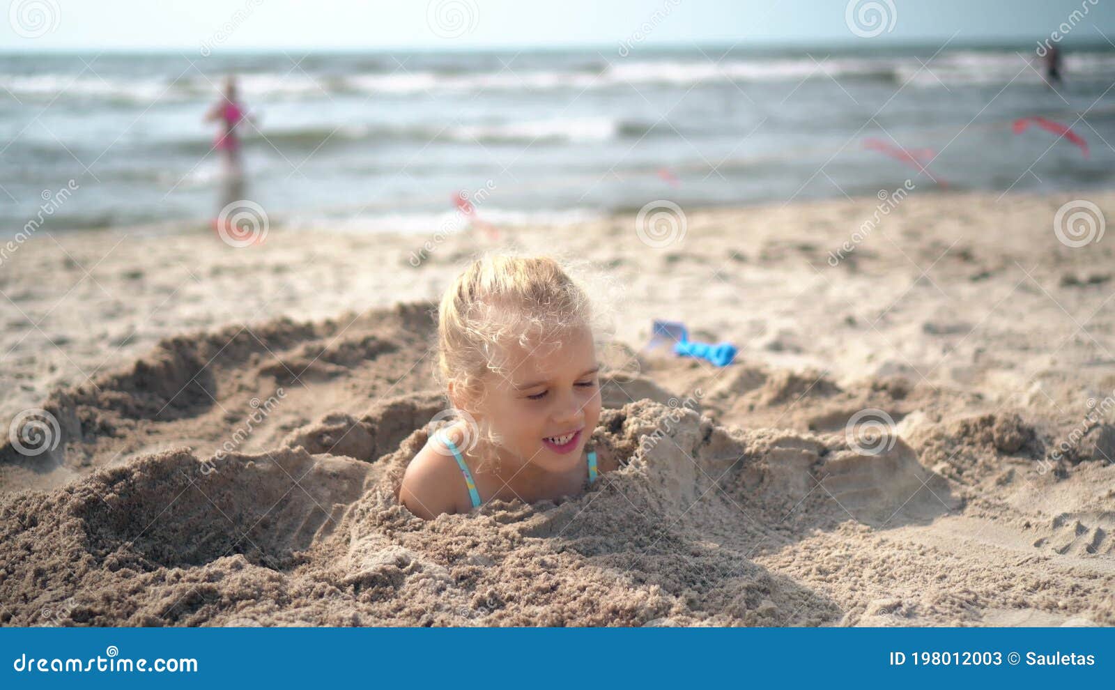 Young Funny Girl is Buried in Beach Sand. Blurred People and Sea on Background Stock Video - Video of holiday, people: 198012003 Young Funny Girl is Buried in Beach Sand. Blurred People and Sea on Background Stock Video - Video of holiday, people: 198012003