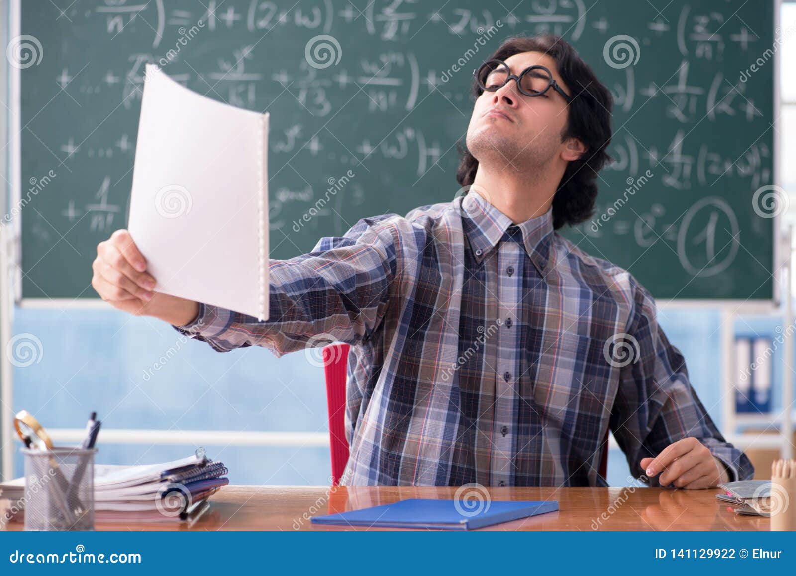 The Young Funny Math Teacher In Front Of Chalkboard Stock Photo 141129922 -  Megapixl